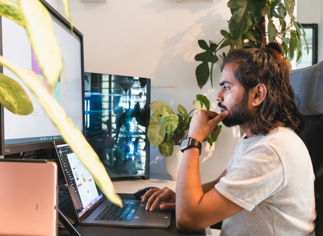 Adult reflecting while working at a laptop