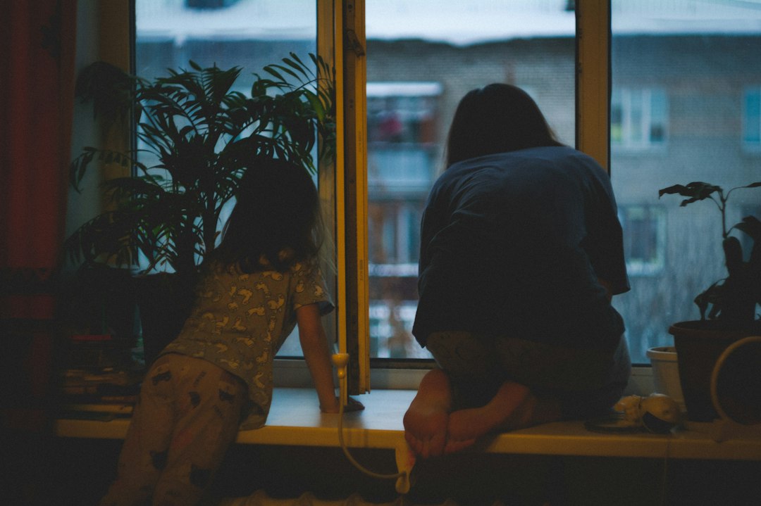 Parent and child together near a window